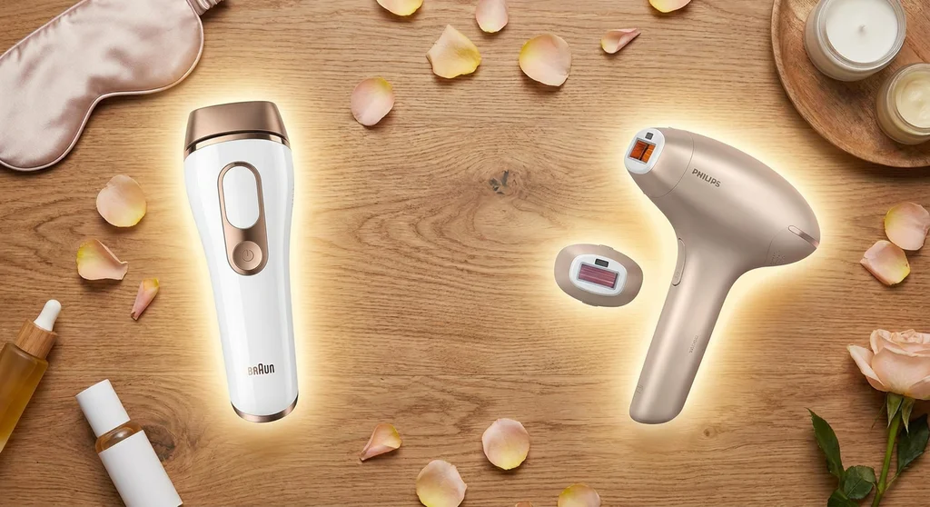 Depilator IPL Braun Silk-expert oraz depilator Philips Lumea z dodatkową nasadką na drewnianym blacie.